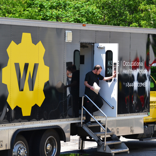 Worksite Medical® team member walking out of a mobile medical unit