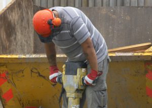 Worker Jackhammering on a loud job site - Hearing Conservation Program - Worksite Medical