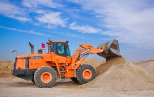 Excavator in sand - silica dust safety in construction