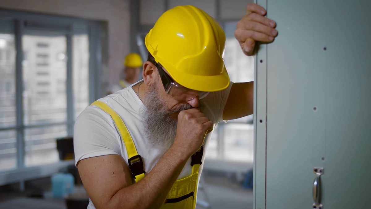Occupational Asthma - man coughing from asthma attack at work