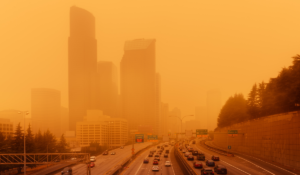 Summer wildfire smoke creating orange skies over a city, affecting respiratory health
