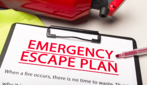 Workplace Evacuation Plan - A photo of a clipboard with a paper which reads "Emergency Escape Plan" in large, bold, red letters