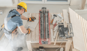 A man cutting a tile and creating dangerous airborne dust