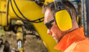 A worker wearing ear muffs for National Protect Your Hearing Month