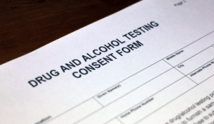 A close-up of drug and alcohol testing consent form. Recently, the DOT amended its rule regarding oral fluid testing