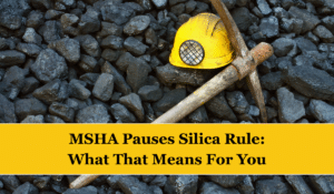 A large pile of coal with a miner's helmet and pick laying on top. Text reads "MSHA Pauses Silica Rule: What That Means For You"